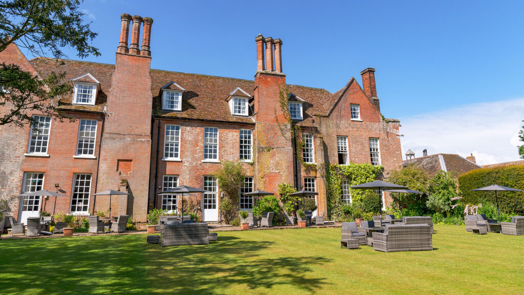 Exterior of Hintlesham Hall Hotel, Suffolk, showcasing its historic architecture and beautiful surroundings - Classic British Hotels
