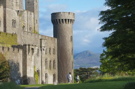 Visitors at Penrhyn Castle, Gwynedd, North Wales. Penrhyn Castle was built in the neo-Norman style between 1820-1840 to the design of Thomas Hopper.