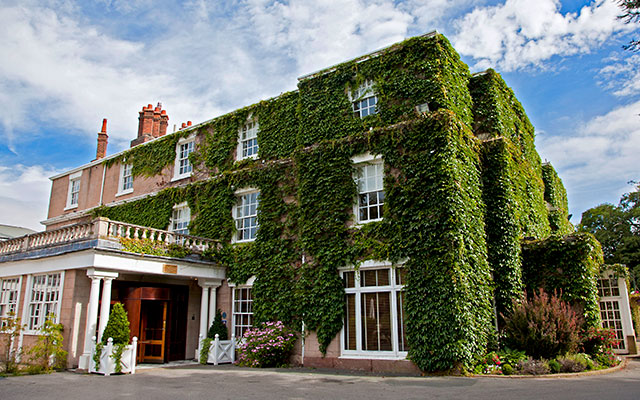 Exterior shot of hotel with ivy covered walls - Rowton Hall Hotel, Chester, Cheshire