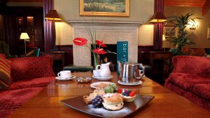 A pot of tea and plate of sweet treats in the lounge - Donnington Valley Hotel, Golf & Spa, Newbury