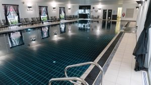 Indoor 18 metre swimming pool and poolside seating - Fairlawns Hotel & Spa, Walsall