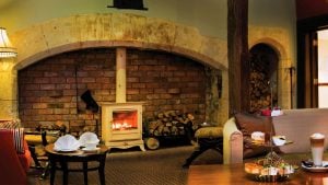 Afternoon tea served in front of a roaring fire in the lounge - Hatherley Manor Hotel & Spa, Cotswolds