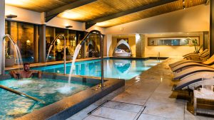 Vitality pool with jets, indoor swimming pool and comfy seating - Hatherley Manor Hotel & Spa, Cotswolds