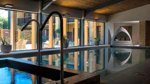 The indoor pool with pod seating - Hatherley Manor Hotel & Spa, Cotswolds