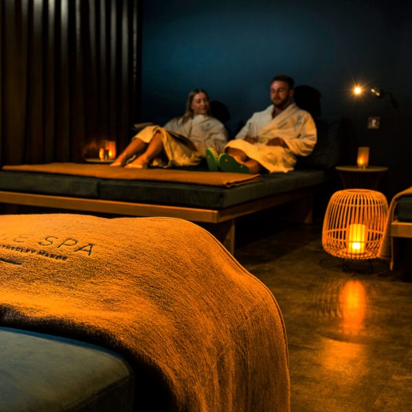 A couple relaxing in the Relaxtaion room - Hatherley Manor Hotel & Spa, Cotswolds