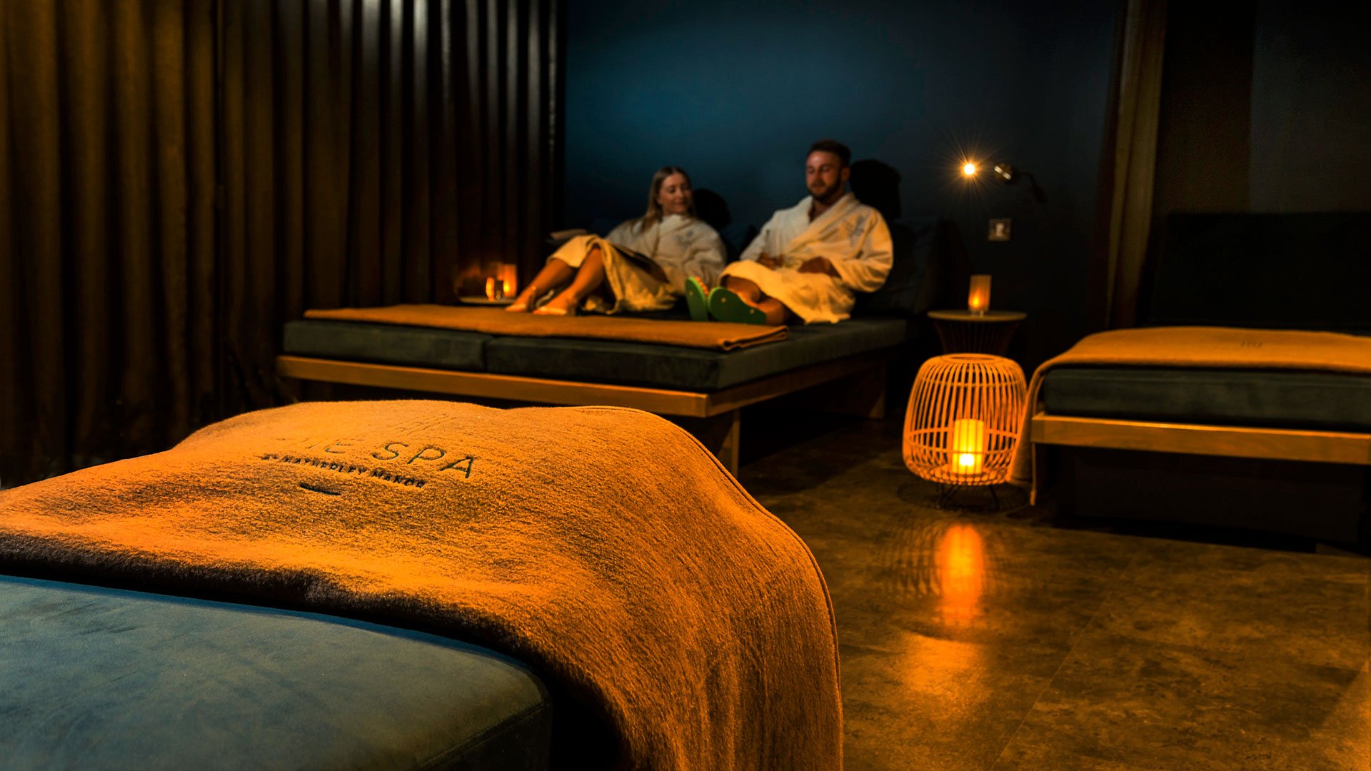 A couple relaxing in the Relaxtaion room - Hatherley Manor Hotel & Spa, Cotswolds