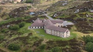 Aerial shot of the hotel in its rugged surroundings - Inver Lodge Hotel, Loch Inver