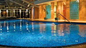 Indoor pool lit up at night - Metropole Hotel & Spa, Llandrindod Wells