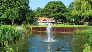View of the golf clubhouse over a water feature - Nailcote Hall Hotel, Warwickshire