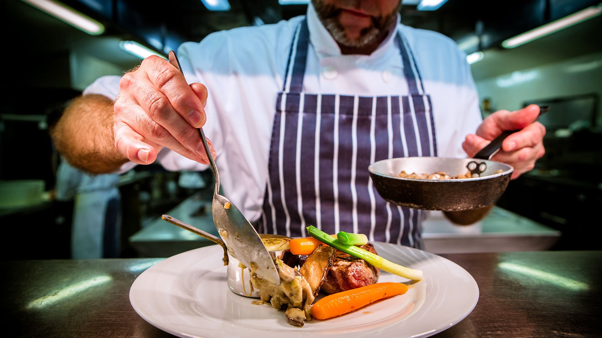Chef serving food at Seasons Restaurant, Park Farm Hotel