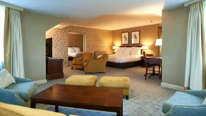 Bedroom and seating area in a Junior Turret Suite - Dalmahoy Hotel & Country Club, Edinburgh