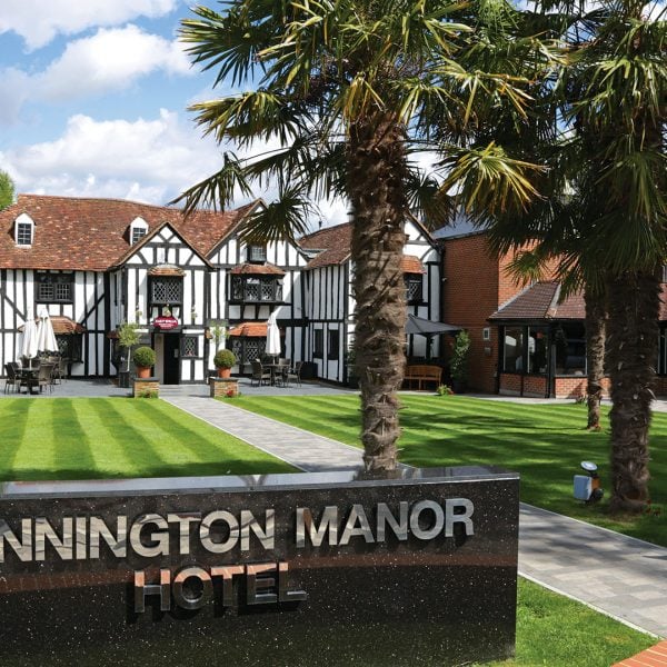 The hotel exterior with palm trees by day - Donnington Manor Hotel, Sevenoaks