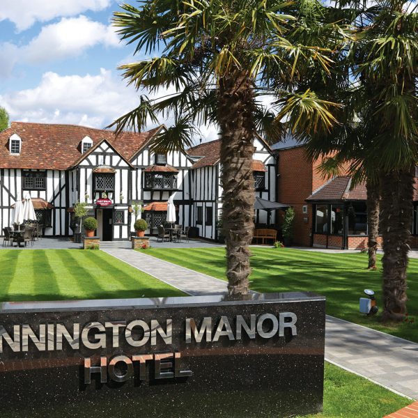 The hotel exterior with palm trees by day - Donnington Manor Hotel, Sevenoaks