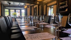 A large table set for dinner in the Osteria Chartwell Restaurant - Donnington Manor Hotel, Sevenoaks