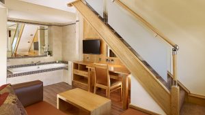 The seating area and bath in a Junior Suite - Fairlawns Hotel & Spa, Walsall