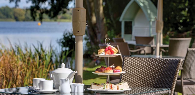 Afternoon tea served on the lawn overlooking the pond - Frensham Pond Country House Hotel & Spa, Farnham