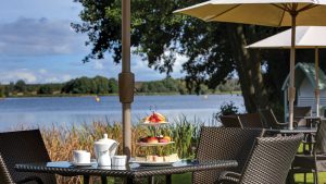 Afternoon tea served on the lawn overlooking the pond - Frensham Pond Country House Hotel & Spa, Farnham