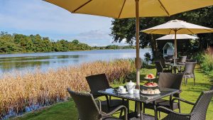 Afternoon tea served on the lawn overlooking the pond - Frensham Pond Country House Hotel & Spa, Farnham