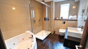 The bathroom in the Honeymoon Suite - Frensham Pond Country House Hotel & Spa, Farnham