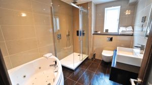 The bathroom in the Honeymoon Suite - Frensham Pond Country House Hotel & Spa, Farnham