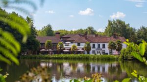 View of the hotel from across the pond - Frensham Pond Country House Hotel & Spa, Farnham