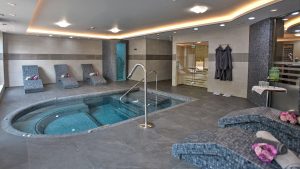 Vitality and wellness pool surrounded by heated loungers - Frensham Pond Country House Hotel & Spa, Farnham