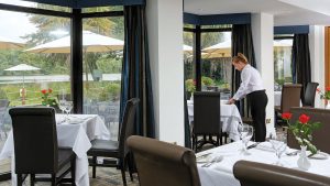 The Watermark Restaurant being set for dinner - Frensham Pond Country House Hotel & Spa, Farnham