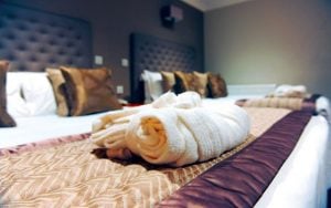 Robes and slippers folded neatly on the bed of an Executive Twin Room - Stoke By Nayland, Suffolk