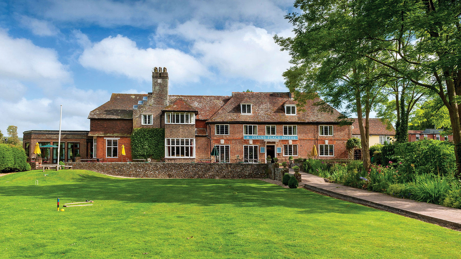 Exterior of the building on a sunny day - Deans Place Hotel, South Downs