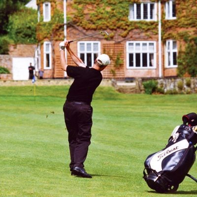 A golfer on the fairway close to the Grade II listed club house - Donnington Valley Hotel, Golf & Spa, Newbury