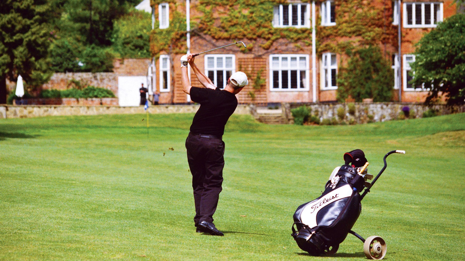 A golfer on the fairway close to the Grade II listed club house - Donnington Valley Hotel, Golf & Spa, Newbury