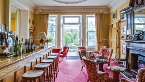 A relaxed drink at the bar in elegant surroundings with views over the countryside - Gliffaes Country House Hotel, Brecon Beacons