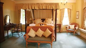 Four poster bed in a Premier lake view room - Lake Vyrnwy Hotel & Spa, Snowdonia