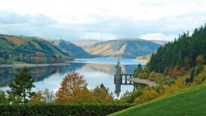 The view of the straining tower on the lake in the Autumn foliage - Lake Vyrnwy Hotel & Spa, Snowdonia