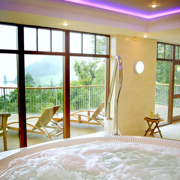 The hot tub and decking overlooking the Lake - Lake Vyrnwy Hotel & Spa, Snowdonia