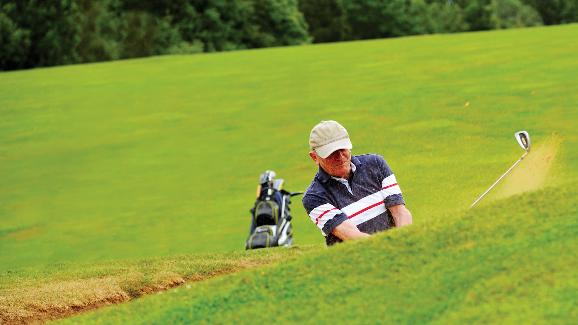 Man playing golf on the Stoke by Nayland Hotel Golf & Spa's golf course in Suffolk.