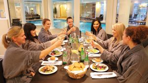 A group of friends enjoying lunch in the Peake Bistro at the Spa - Stoke by Nayland Hotel, Golf & Spa