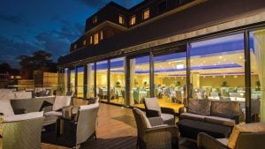 The restaurant terrace lit up at night - The Lensbury, Teddington