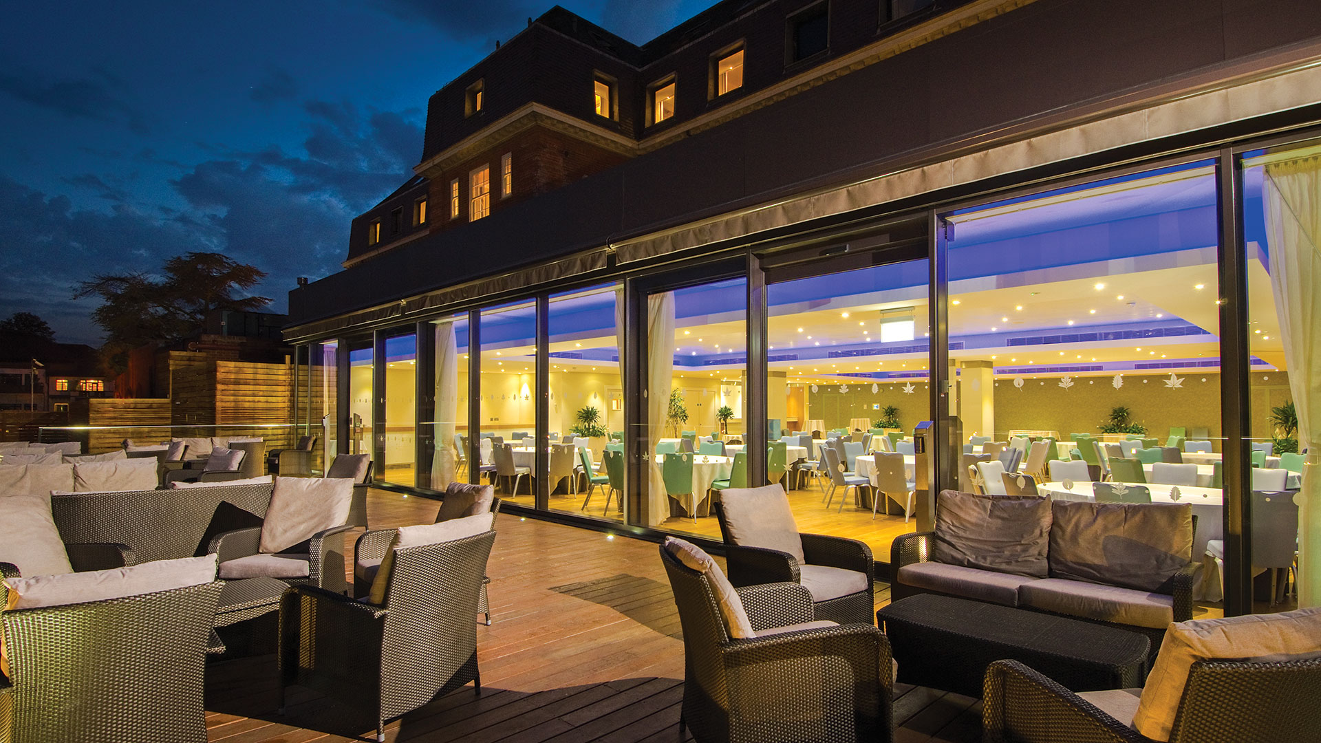The restaurant terrace lit up at night - The Lensbury, Teddington
