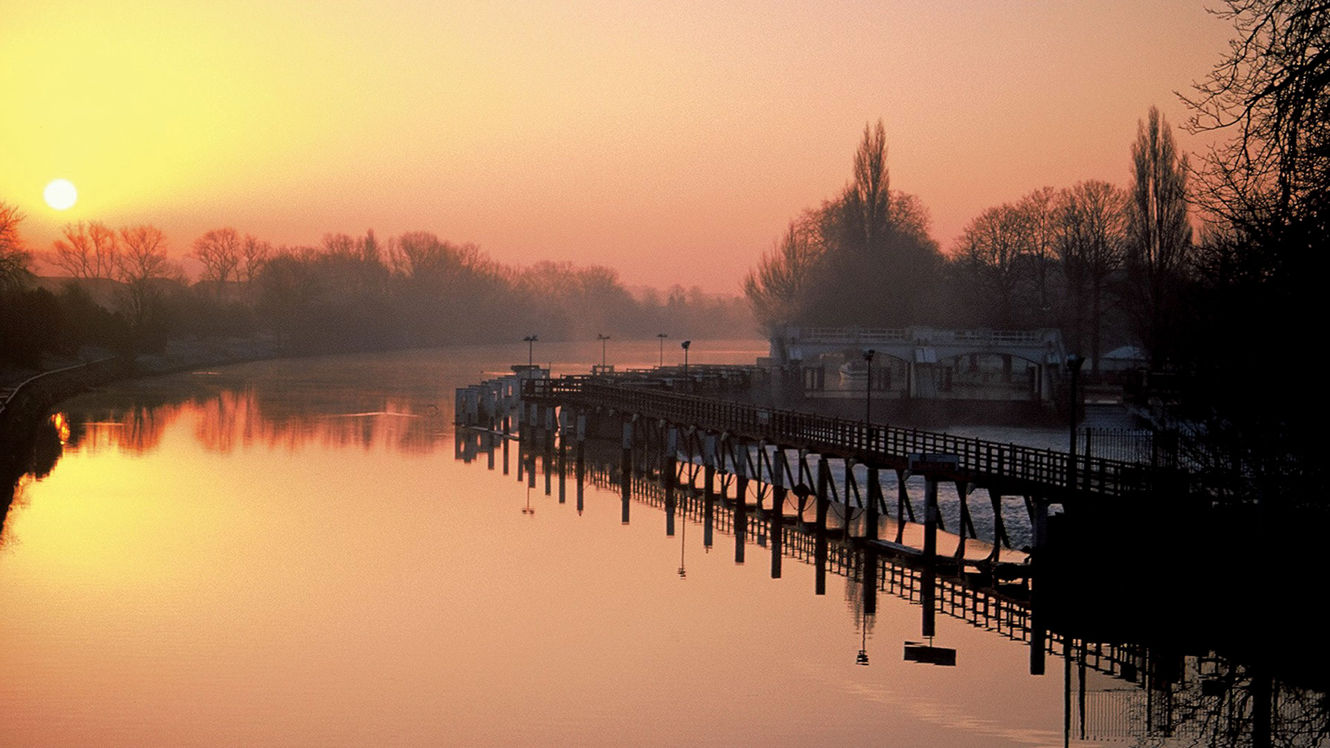 The river Thames lit up by sunrise on a chilly morning - The Lensbury, Teddington