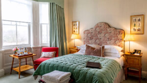 Deluxe double room at The Jockey Club, Newmarket, with plush bedding and elegant decor