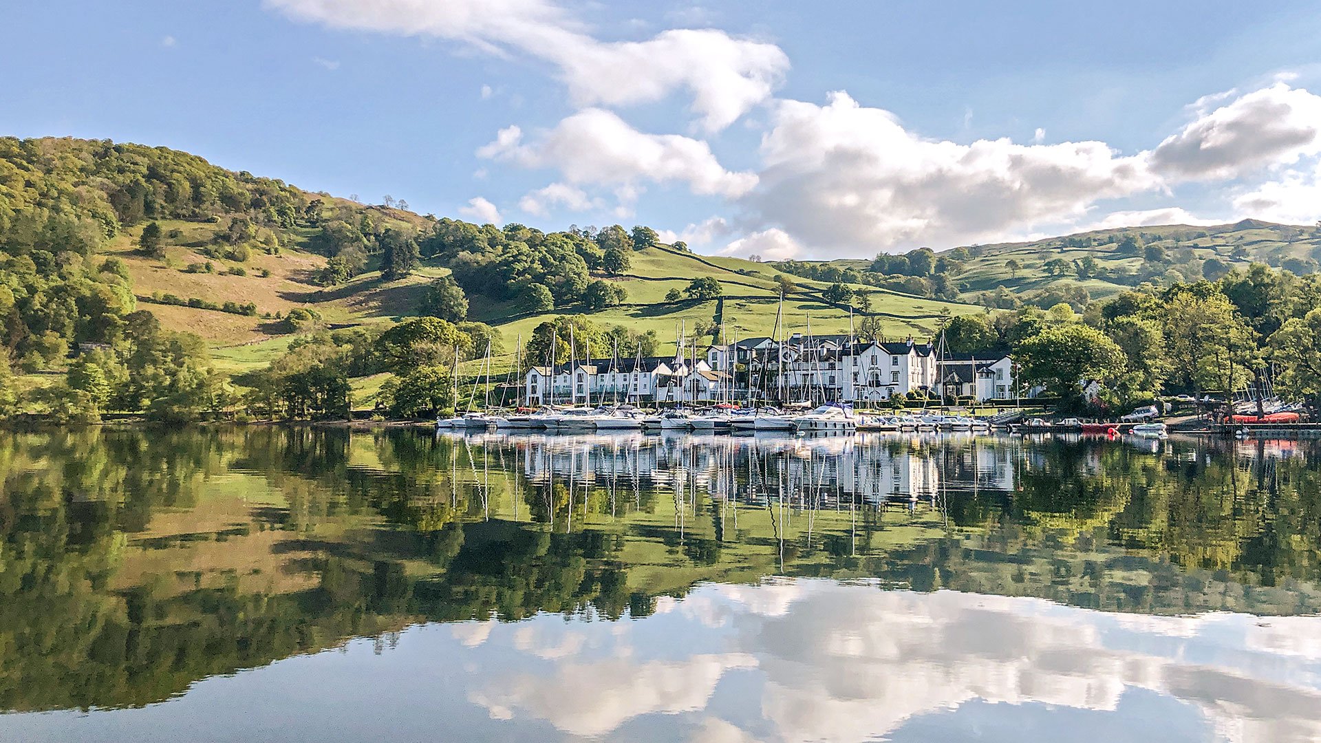 The hotel on the edge of the lake with rolling hills behind it - Low Wood Bay Resort, Lake Windermere