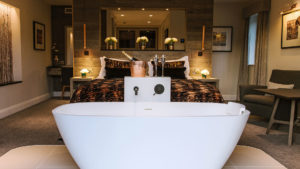 Winander Club Lime Room with bathtub at the end of the bed - Low Wood Bay Resort, Lake Windermere