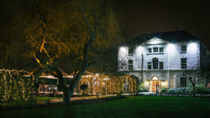 The original house overlooking the lawns, lit up at night - Van Dyk Hotel, Chesterfield