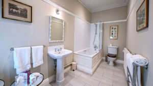 Deluxe double room bathroom at The Jockey Club, Newmarket, with sleek design.
