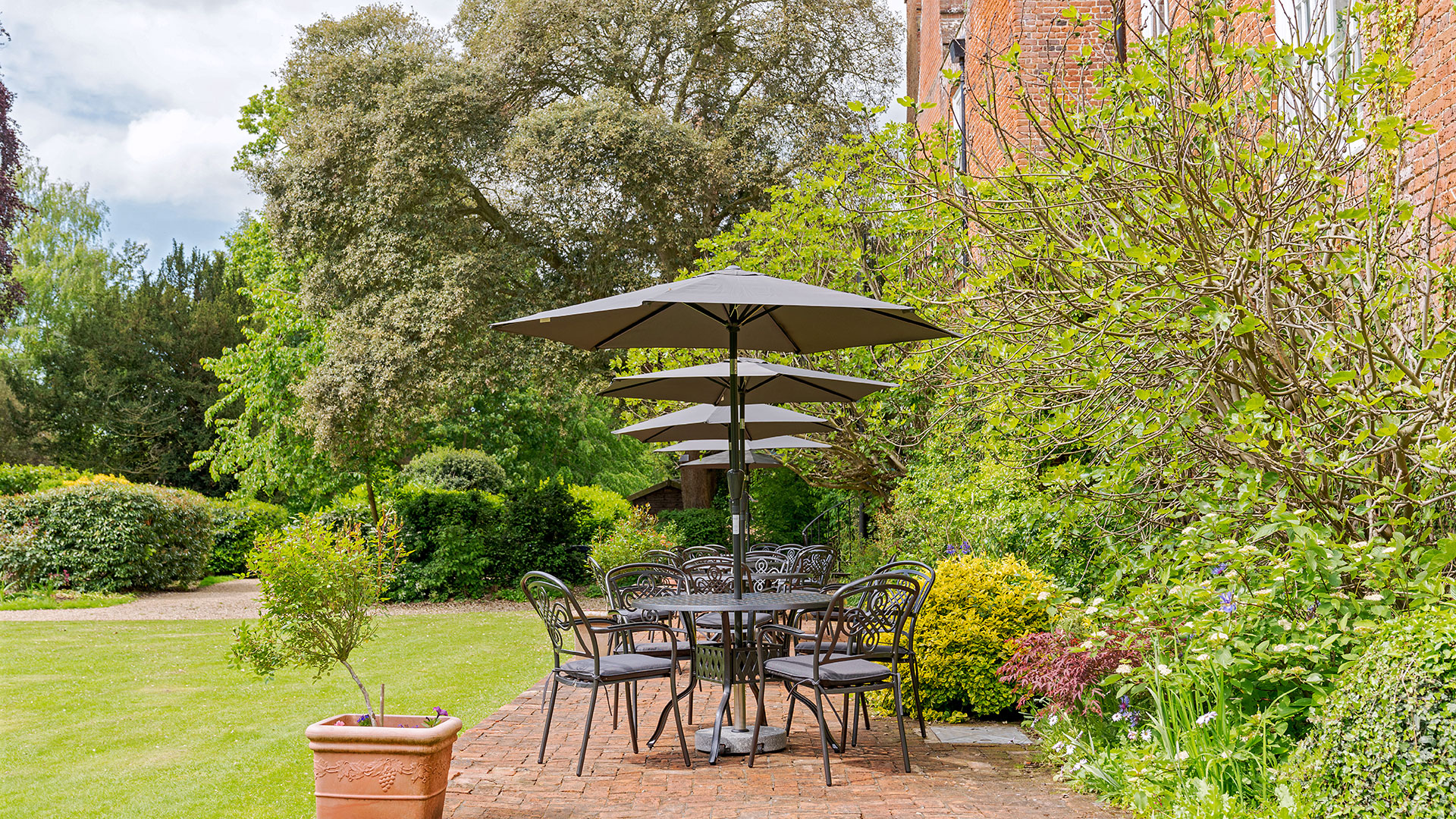 Beautiful gardens at Hintlesham Hall Hotel in Suffolk, featuring lush greenery and a serene atmosphere for relaxation - Classic British Hotels