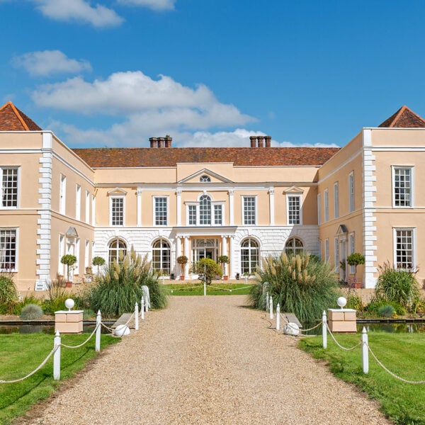 Exterior view of Hintlesham Hall Hotel in Suffolk, showcasing its historic architecture and picturesque surroundings - Classic British Hotels