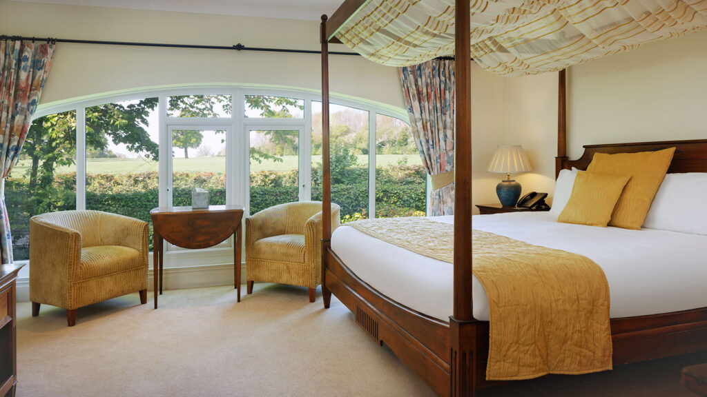 Elegant four-poster bed in the Nailcote Hall Hotel, Warwickshire